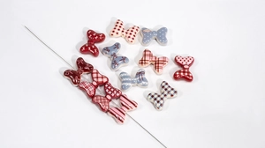 Macro shot of assorted butterfly bow resin beads with detailed patterns for DIY jewelry making