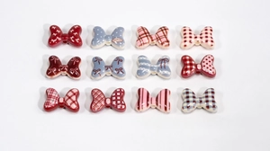 Detail view of colorful patterned resin butterfly charms for DIY jewelry making