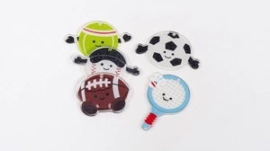 Close-up of glittery acrylic sports charms featuring cute cartoon ball designs