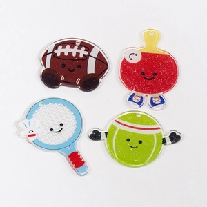 Cute acrylic sports keychains with glitter, featuring football, tennis and rackets designs