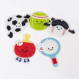 Glittery acrylic cartoon sports charms featuring soccer tennis baseball and rackets
