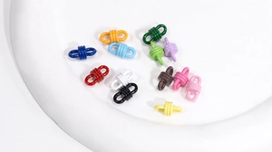 Close-up of colorful alloy knot spiral connectors for DIY jewelry and phone charms