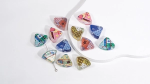 Macro shot of patchwork printed triangle acrylic beads with through-holes for DIY jewelry