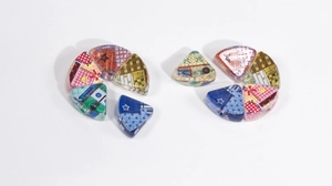 Macro shot of triangular acrylic beads with vintage patterns for DIY keychains