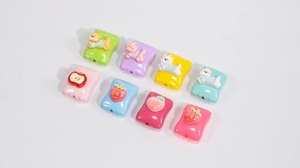 Detailed view of colorful acrylic cartoon fruit and animal beads for DIY jewelry making