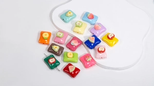 Macro detail of colorful acrylic candy beads with various fruit decors and functional holes