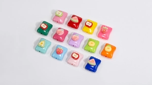 Macro detail of square acrylic beads with 3D fruit motifs for DIY jewelry making
