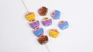 Close-up of colorful acrylic handbag beads with polka dots and stars for DIY crafts