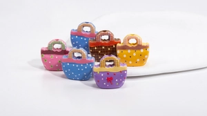 Close-up of colorful acrylic handbag beads with polka dots and stars for DIY jewelry