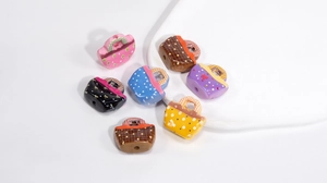 Close-up of colorful acrylic handbag beads with star and floral prints for DIY jewelry