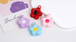 Macro detail of colorful flower pendants with hanging holes for DIY jewelry making