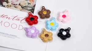 Macro detail of colorful floral alloy pendants for DIY jewelry and bag accessories