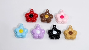 Flat lay of colorful flower-shaped DIY pendants with glossy finish for accessory making