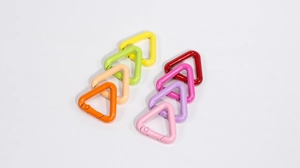 Close-up of assorted colorful triangular spring snap hooks in eight vibrant shades