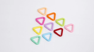 Macro display of colorful triangle carabiner clips with durable painted metal finish