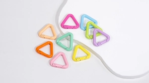 Close-up of colorful triangle carabiner clips in matte paint finish for DIY keychains