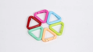 Macro view of colorful triangular alloy snap hooks with spring gate in macaron shades