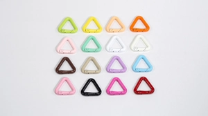 Detail view of sixteen colorful triangular alloy carabiner snap hooks in a neat 4x4 grid