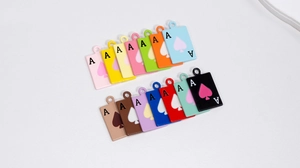 Detailed view of 14 colorful Ace of Spades alloy charms for DIY jewelry making