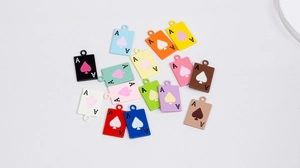 Macro detail of multi-colored Ace of Spades alloy charms for DIY jewelry and keychains