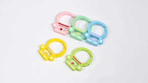 Detail of colorful robot-shaped carabiner clips with matte finish in macaron colors