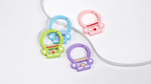 Close-up of astronaut helmet carabiners in pink, blue, green, and purple pastel finishes