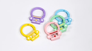 Detail of colorful astronaut spring snap hooks in various matte painted metal finishes