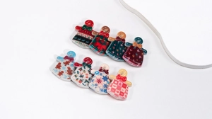Macro detail of Christmas acrylic beads with gingerbread man and snowflake patterns