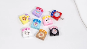 Macro view of assorted colorful acrylic telephone-shaped beads with cute animal designs for DIY