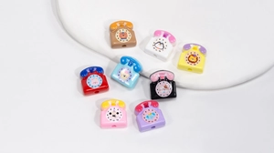 Close-up of retro acrylic telephone beads with cartoon animal dials for DIY jewelry making