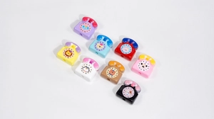 Close-up of colorful acrylic retro phone beads with cartoon animals and dial for DIY crafts