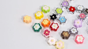 Macro view of colorful acrylic six-petal flower beads with side holes for DIY jewelry