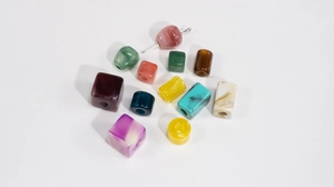 Macro shot of colorful faux jade resin beads in various shapes for DIY jewelry making