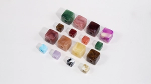 Close-up of square acrylic beads with marble texture for DIY jewelry and phone chains