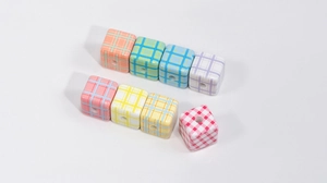 Macro shot of colorful checkered acrylic cube beads with center holes for DIY jewelry