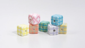Macro detail of colorful checkered acrylic cube beads for DIY jewelry and phone chains