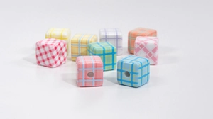 Detailed macro view of checkered acrylic cube beads for DIY jewelry and phone chains