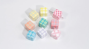Macro shot of colorful checkered acrylic cube beads for DIY jewelry and phone chains
