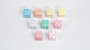 Macro shot of colorful checkered acrylic cube beads with holes for DIY jewelry making