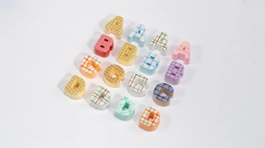 Macro shot of colorful plaid alphabet beads for DIY jewelry and phone chain making