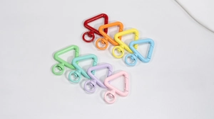 Macro shot of colorful triangle spring hooks in eight vibrant painted metal finishes