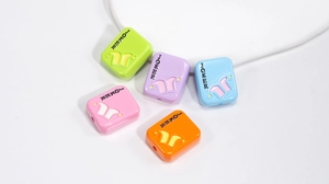 Macro detail of acrylic JOKER square beads in five candy colors for DIY jewelry making