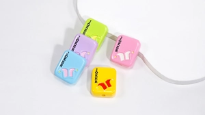 Macro detail of acrylic Joker beads in pastel colors for DIY jewelry and crafts