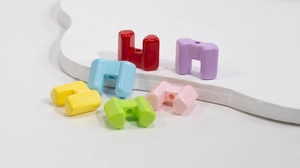 Detail view of U-shaped acrylic beads in vibrant colors for DIY jewelry making