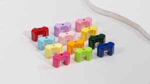 Colorful U-shaped acrylic beads arranged in a vibrant grid for DIY jewelry making