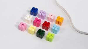 Macro shot of colorful acrylic flower beads with center holes for DIY jewelry making