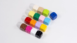 Close-up of colorful acrylic dice beads with center holes for DIY jewelry and crafts