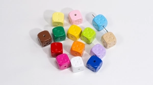 Macro shot of colorful acrylic dice beads with large holes for DIY jewelry making