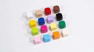Macro shot of colorful acrylic cube dice beads with precision drilled holes for DIY jewelry