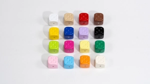 Detailed macro view of sixteen colorful acrylic dice beads for DIY jewelry and crafts